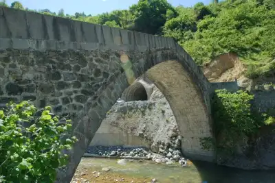 Stone structure of Yaglidere Aga Bridge in a green valley