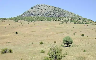 Timbriada Ancient City meadow area and mountain view