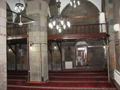 Muezzin's loggia and light fixtures inside Alaeddin Bey Mosque
