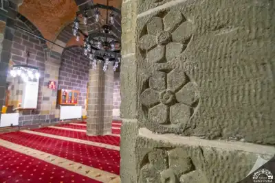 Carved stone wall decorations inside Alaeddin Bey Mosque