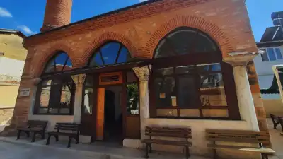 Red brick arched entrance of Alaeddin Bey Mosque